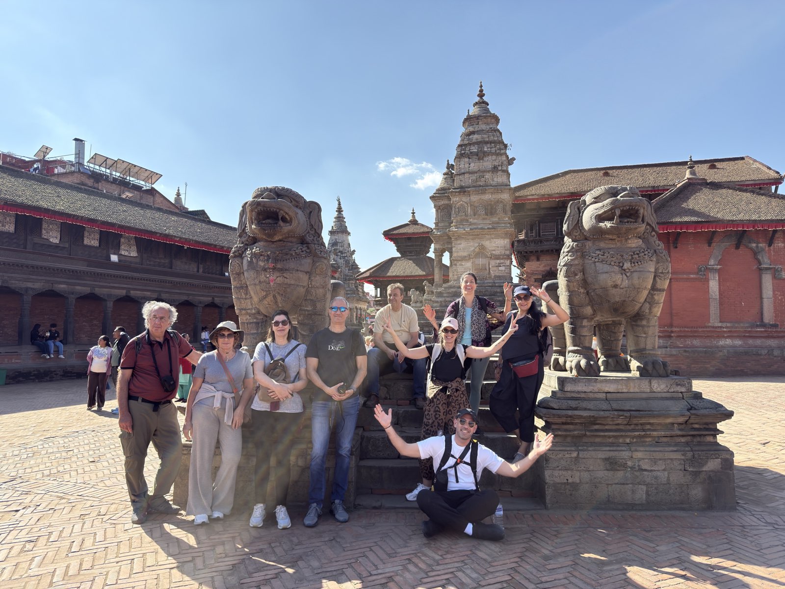 A travelling group in front of the stone lions of Durbar Square in Bhaktapur, Nepal