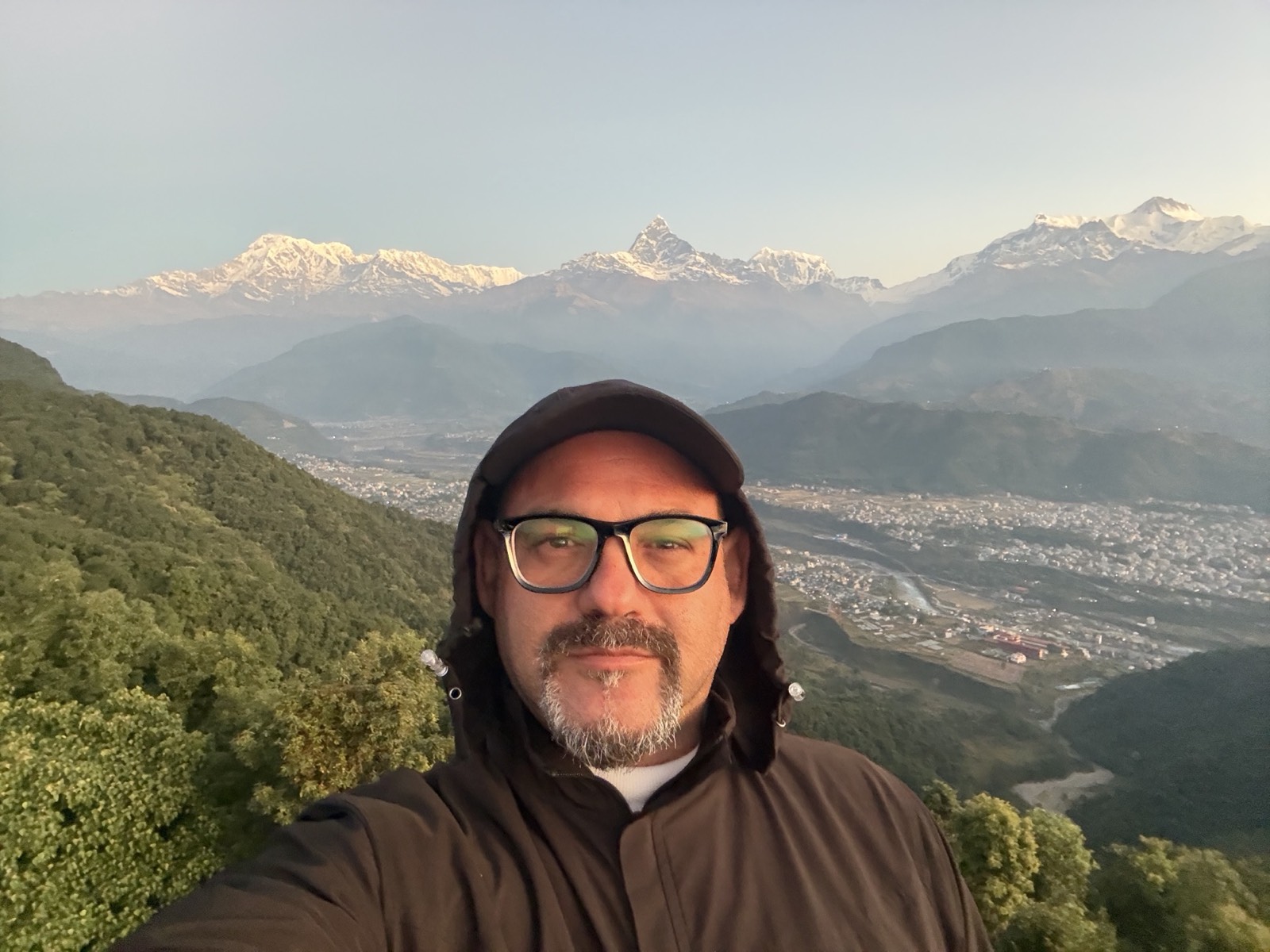 Dimitrios Giannopoulos on the hill above Pokhara, with the Annapurna range and Machhapuchhre behind him