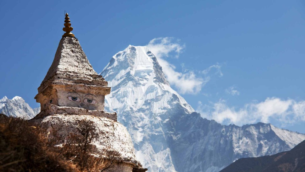 Private helicopter landing on remote Himalayan peak with panoramic mountain views Nepal