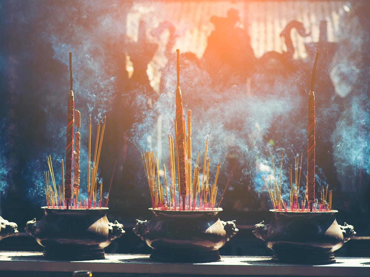 Buddhist monastery meditation hall with prayer flags and monks in Himalayan Nepal